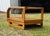 Solid oak side table is manufactured by The Stratford Company in the style of Lou Hodges. This post-modern piece has a...