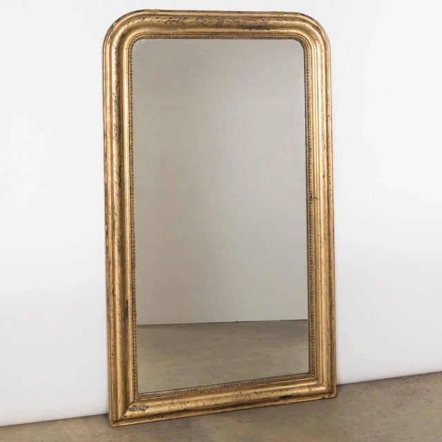 Antique French 19th Century Louis Philippe style gold gilt mirror intricately etched with an intertwining design of ivy...