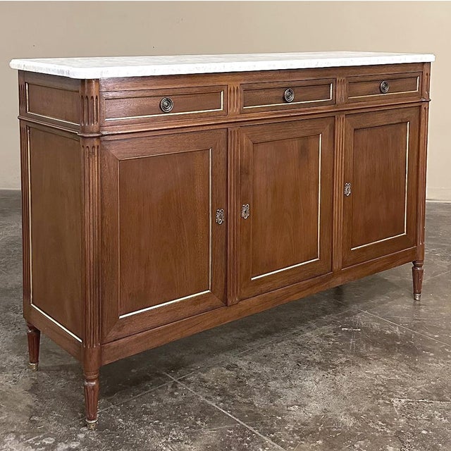Antique French Louis XVI Mahogany Buffet with Carrara Marble represents the epitome of understated elegance. Hand-crafted...