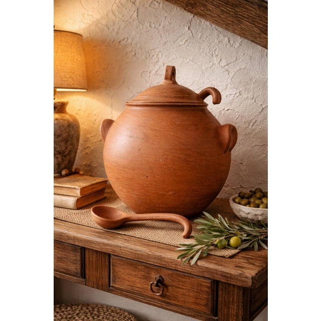 This substantial hand-formed terracotta lidded vessel exudes old-world Mediterranean character. Crafted in warm natural...