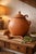 This substantial hand-formed terracotta lidded vessel exudes old-world Mediterranean character. Crafted in warm natural...