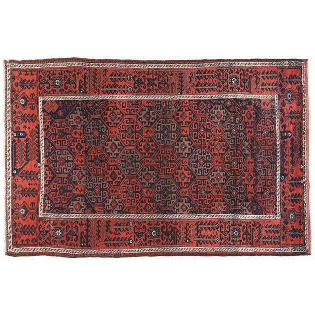 This authentic antique Beluch rug showcases a striking geometric medallion field rendered in richly saturated natural...