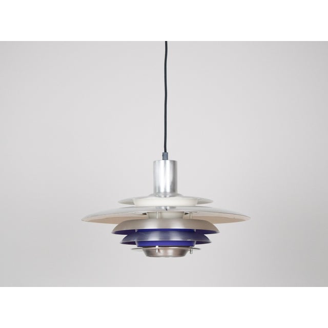 The lamp's form was designed based on the principle of a reflective system that directs light not only downward but also...