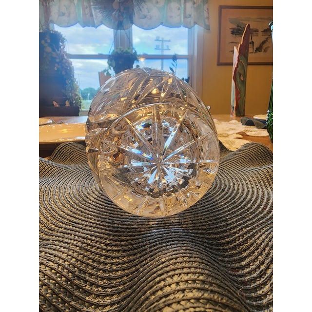 This gorgeous vase showcases frosted, hand-etched floral elements resembling flowers and detailed leaves. The frame of the...