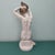 Seating nude woman while combing' sculpture produced by the Herend Porcelain Manufactory in the 20th century in Hungary....