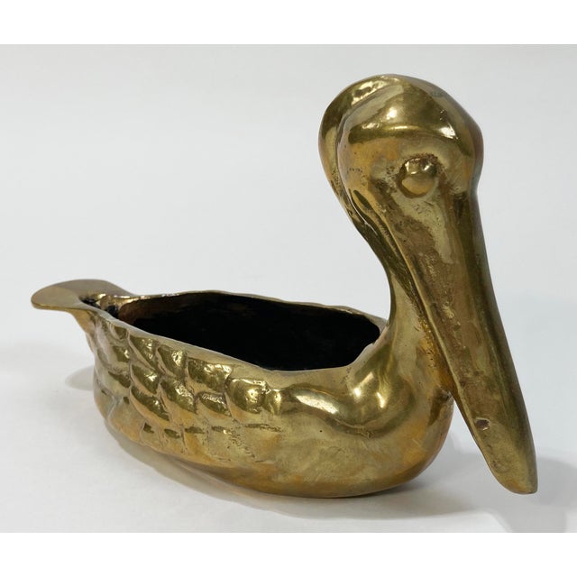 Beautiful detail to this heavy cast brass bowl/catchall/planter in the shape of a pelican or seagull. Nice design detail...