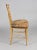French giltwood salon side chair, the top rail centered by a carved ribboned bow and wheat sheaths, the legs and...