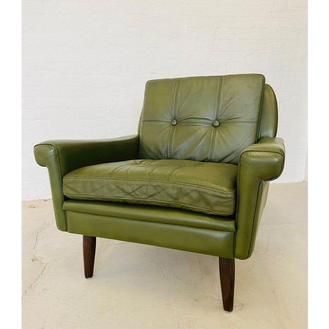 Made in Denmark by Svend Skipper, a beautiful classic Danish lounge chair upholstered in soft Olive green leather, the...