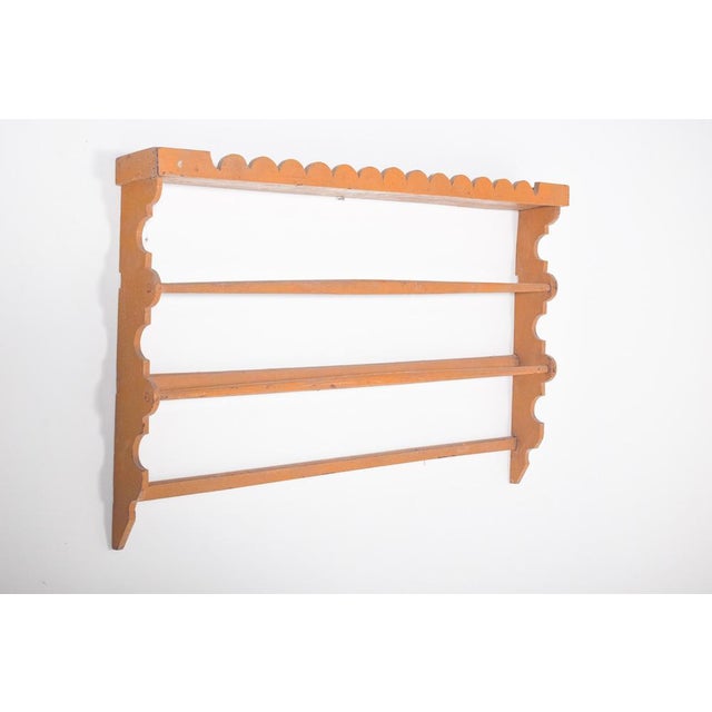 This rustic plate rack, crafted in wood and painted in a warm toasted yellow, radiates simplicity and charm. Its design is...