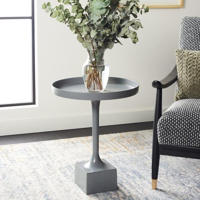 Inspired by the sleek curves of modern metalwork, this Corvus Round Side Table is a contemporary masterpiece. Its dark...