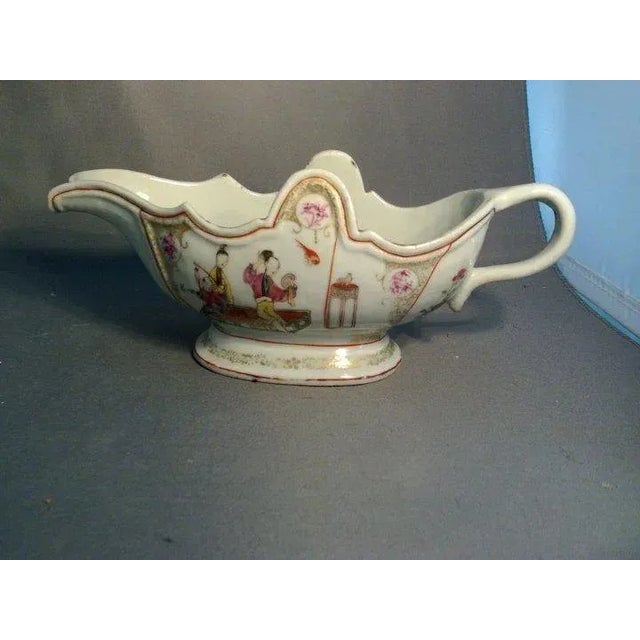 Antique Chinese export porcelain sauce boat decorated with court scenes and flowers all highlighted with gilding. Good...