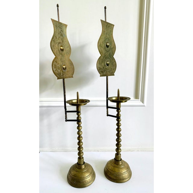 A pair of tall candlesticks fashioned out of solid brass from Korea circa 1900s (end of Joseon Dynasty to Korean Empire...