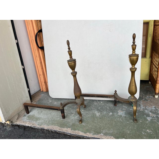 Antique brass and cast iron fireplace hearthware andirons firedogs featuring Traditional Colonial styling with trophy urn...