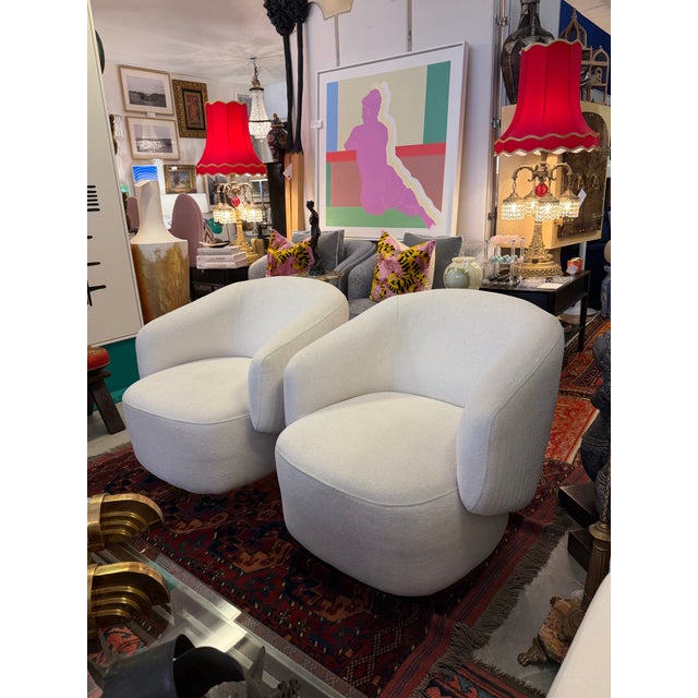 Wonderful comfortable pair of swivel chairs in a soft cream color. The have pinstripe channeling on the exterior backs and...