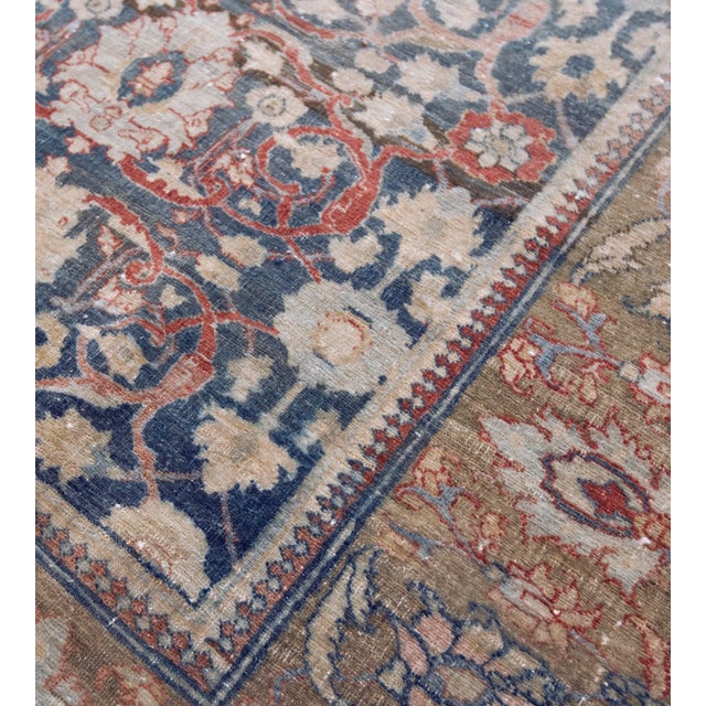 This traditional Tabriz runner has a shaded indigo-field with an overall design of shaded tomato-red vine linking bold...