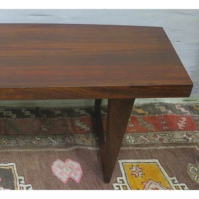 Unusual Danish coffee table, the top curved on one side, standing on sled legs. No markings, but attributed to Leif Hansen...