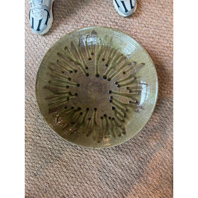 A large ceramic platter crafted in Japan during the 20th century. In style of Mashiko ware. Finished with a rich green...