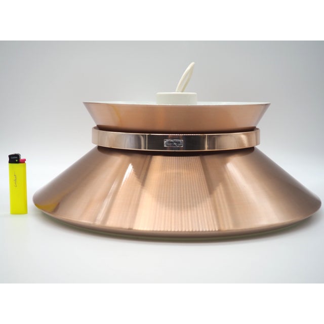 A beauteful vintage copper coloured ceiling lamp that provides a pleasant light. with white metal, and a white plastic...