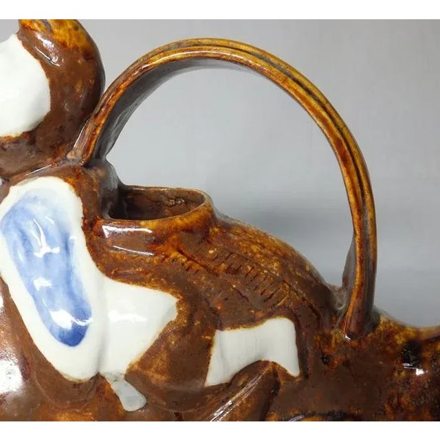 A charming ewer for sake from the Edo period. Hirado porcelain in classic brown glazing with cobalt accents, the ewer...