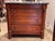 19th century French Empire commode with a molded gray marble top over three drawers, flanked by full columns with brass...