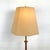 This vintage Mid-Century Modern floor lamp features a sculptural blend of warm walnut and patinated metal, creating a...