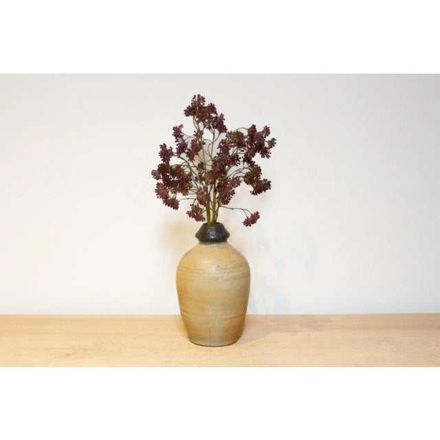 A two tone antique Korean porcelain vase. This antique vase boasts a classic ovoid form, its surface adorned with a...