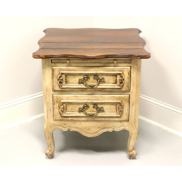 A French Country style nightstand, unbranded. Hardwood painted antique white with a distressed finish to give the...