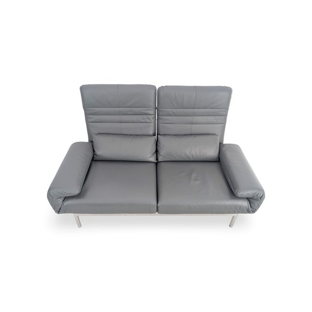 We are offering a beautiful Rolf Benz Plura two-seater sofa in dark gray leather for sale. The sofa impresses with its...