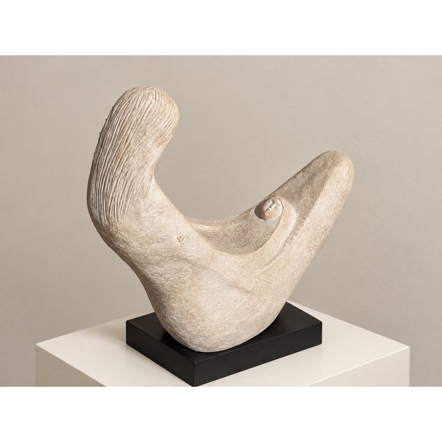 A lyrical mother-and-child sculpture designed by Pamela Pierce for Austin Productions. The mother’s long carved hair and...