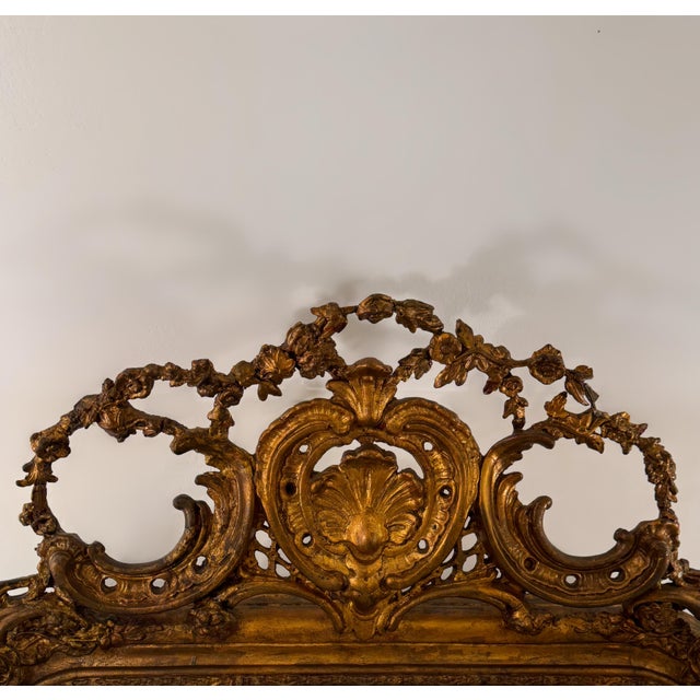 An exquisite original French Rococo mirror dating to the Louis XV period (1715–1774). Carved in solid oak, the frame is...