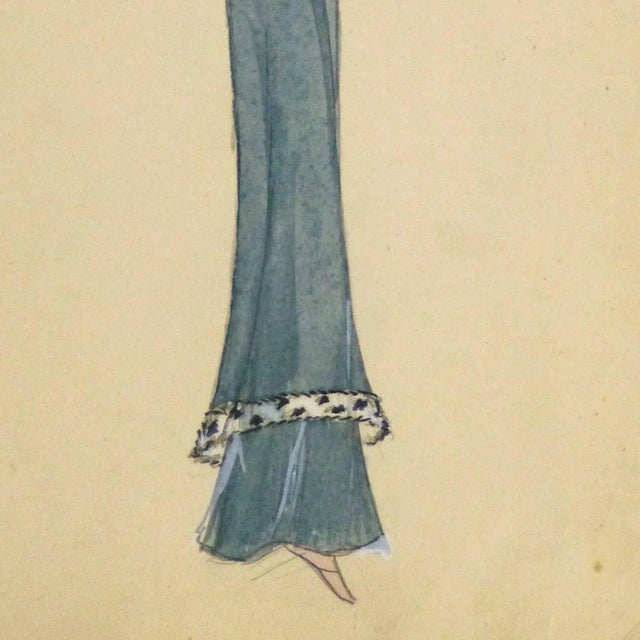 Unique pencil and gouache fashion sketch of a slim and flowing blue evening dress trimmed in white fur, circa 1930....