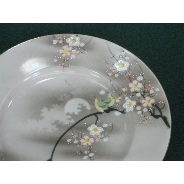 This antique Japanese dessert plate features a beautifully hand-painted image of a bird perched on a moon and tree. The...
