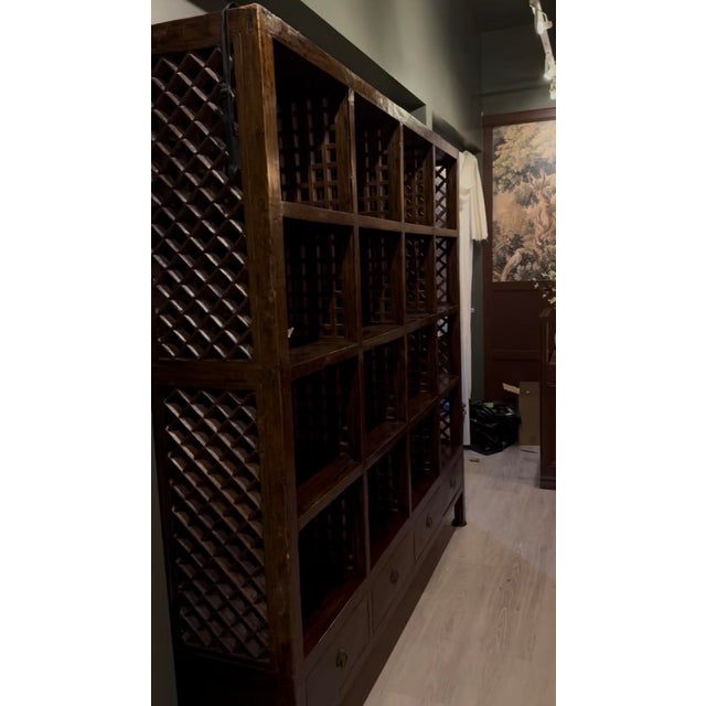 A striking 19th century Chinese elm lattice bookcase, an architectural and highly functional cabinet that would have...