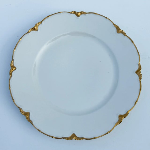 An elegant, antique French Limoges dinner plate from Haviland. The thick gilt ruffled trim makes this a very special...
