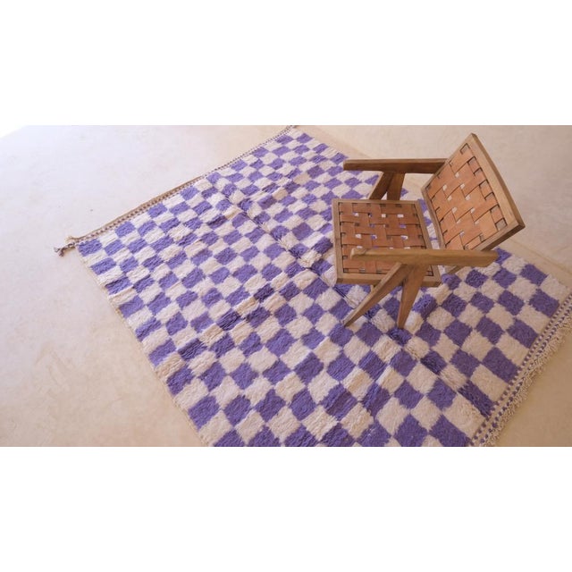 Add a splash of color to your space with our Moroccan Purple Checkered Rug. This modern rug features a stylish checkered...