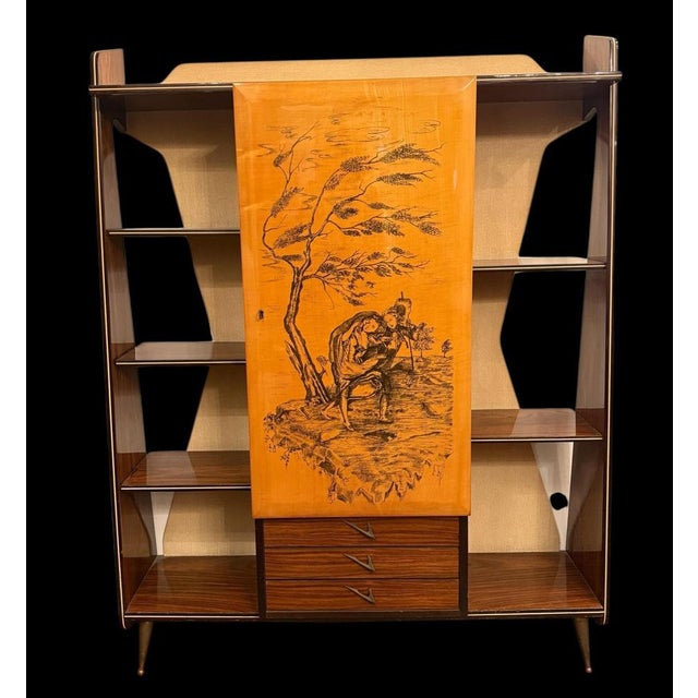 Stylish Italian Mid-Century Modern multifunctional furniture with a bar cabinet with a decorated panel. Three drawers...
