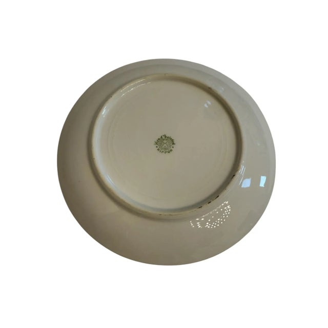 This beautiful hand painted plate features salmon-hued flowers with light yellows, greens, and creams throughout. Made in...