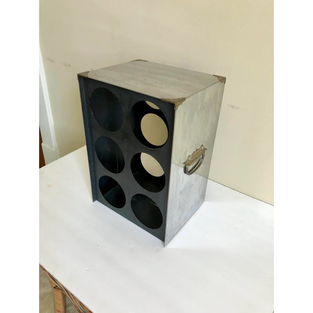 A vintage chrome campaign style 6 bottle wine rack with brass corners and handles.