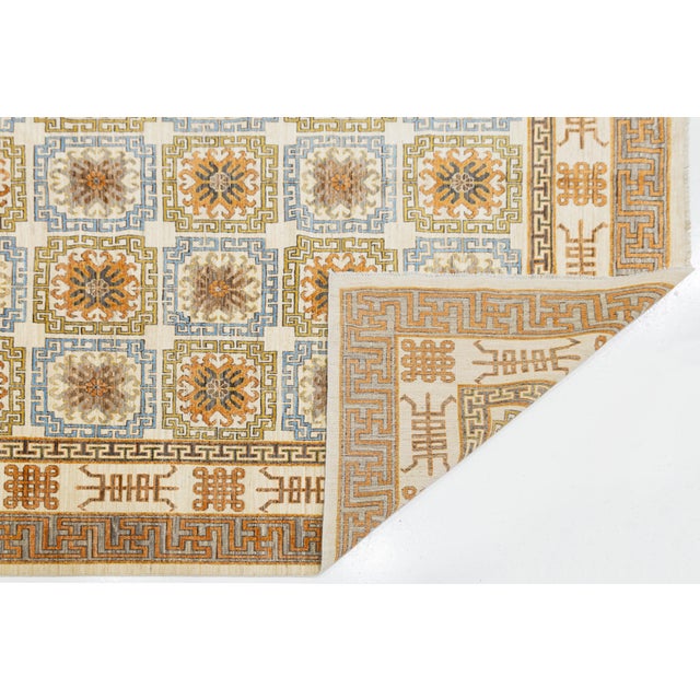 Elevate your space with this stunning Modern Khotan style area rug, expertly hand-knotted from premium wool. Combining...