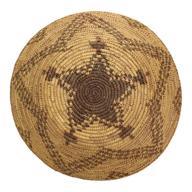 This vintage Native American coiled basket, dating to approximately 1940, showcases traditional Southwest craftsmanship....