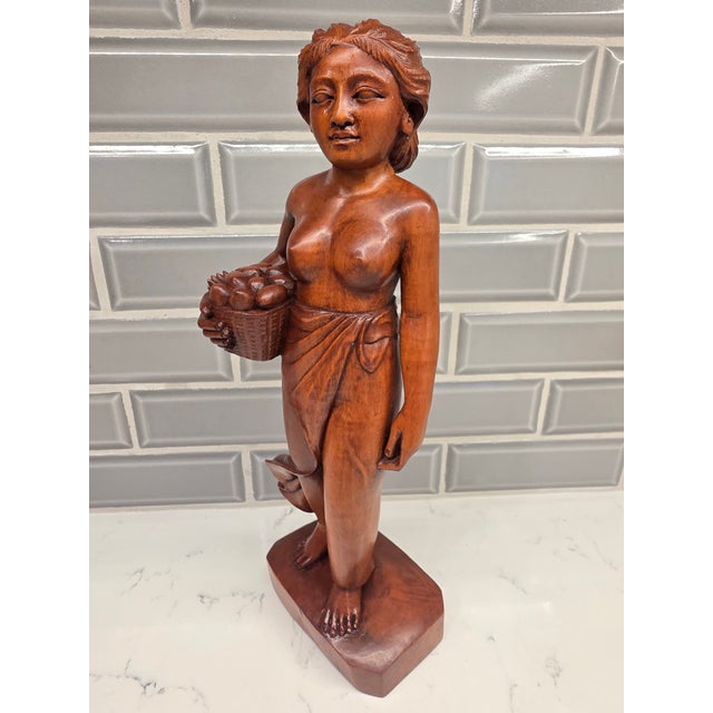 An exceptional mid-century Balinese modernist Art Deco sculpture depicting a traditional harvest maiden. Standing 11.5...