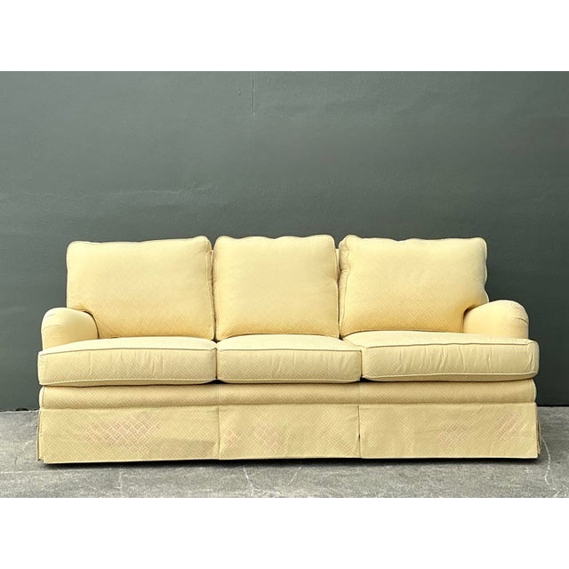 Experience the pinnacle of traditional American craftsmanship with this exquisite vintage three-seat sofa by the renowned...