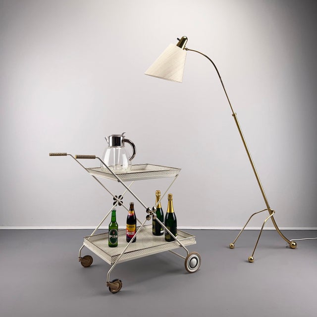 Stylish 1950s serving trolley Manufacturer likely Vereinigte Werkstätten München Metal frame with removable perforated...