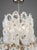 An elegant and sculptural Murano glass waterfall chandelier, attributed to Vistosi, featuring seven lights arranged within...