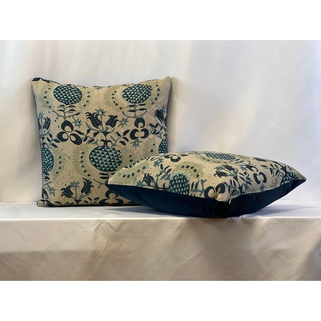 Custom-tailored 20”x20” pillows in pomegranate motif linen. Backs are in deep blue velvet. Hidden zipper closures....