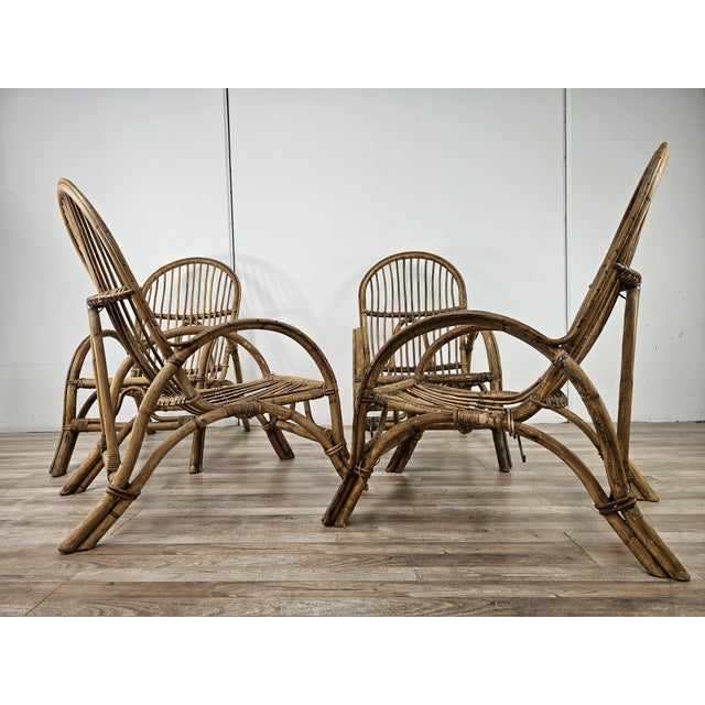 Set of four vintage 1970s wicker and bamboo armchairs. Ideal for decorating an outdoor space, a porch, or an entryway....