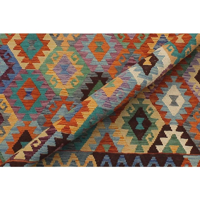 "Add a touch of elegance to your home with this casual chic hand woven Tribal Kilim wool rug. Constructed on a loom by...