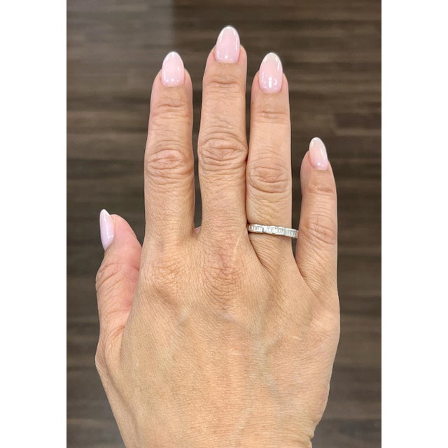 This stunning eternity ring features baguette diamonds all around. The diamonds showcase a color of F/G and VS1/VS2 in...