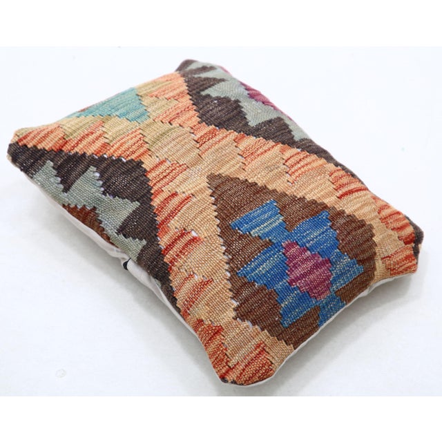 A one-of-a-kind handwoven Afghan wool kilim lumbar pillow featuring zigzag diamond bands. Cut and sewn by hand from a...