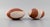 European studio ceramicist. Two rattle instruments in glazed stoneware. Hand-painted wavy decoration in orange-brown...